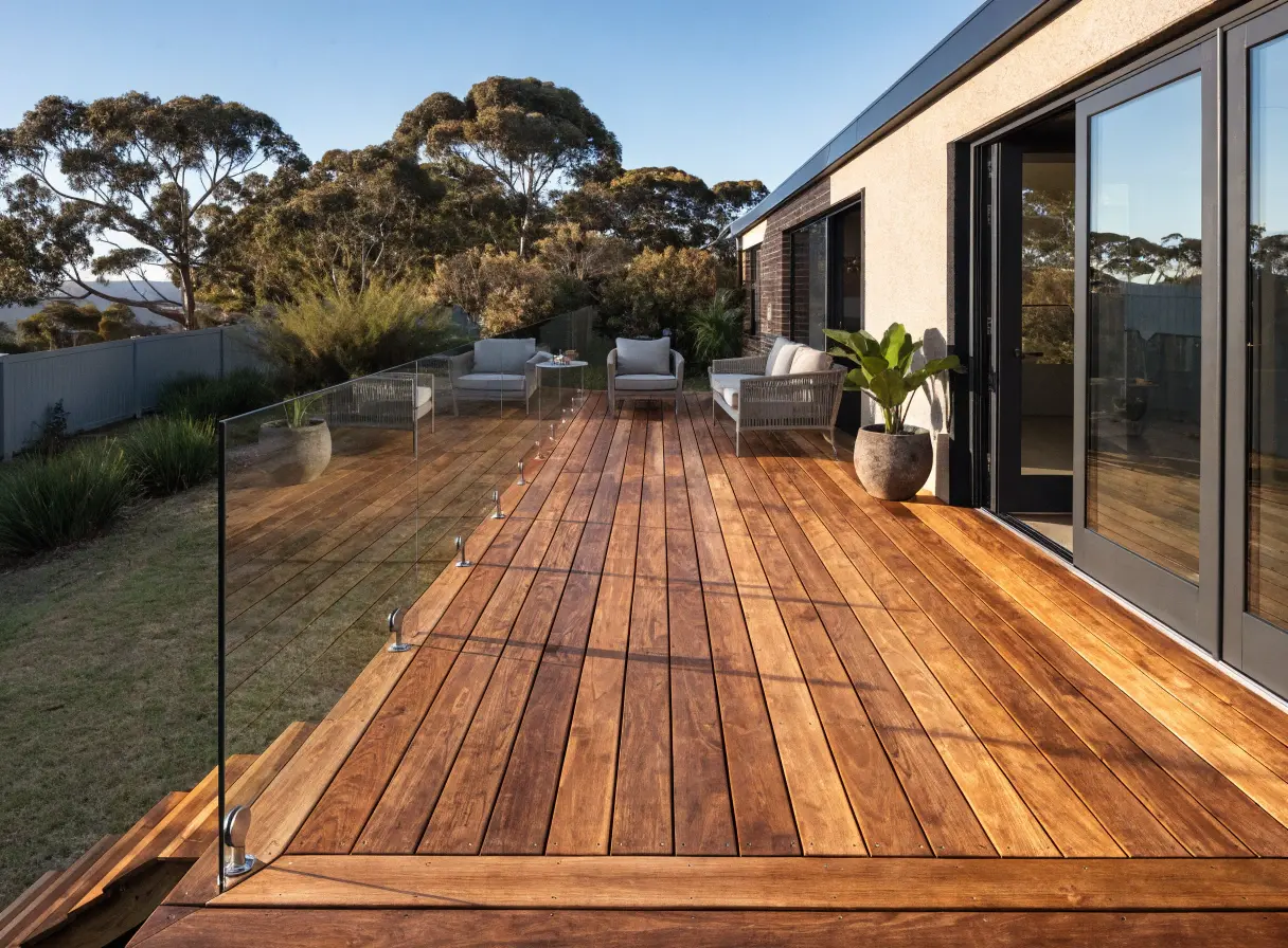 Hardwood deck with glass balustrade and outdoor lounge for entertaining at an Australian home in Wollongong