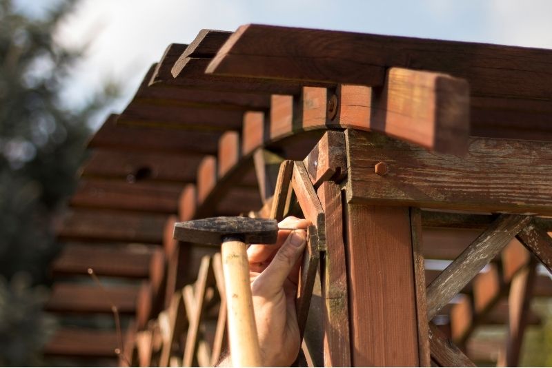 Close-up of a hammer during pergola repair