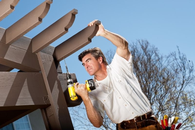 Tradesperson repairing a pergola